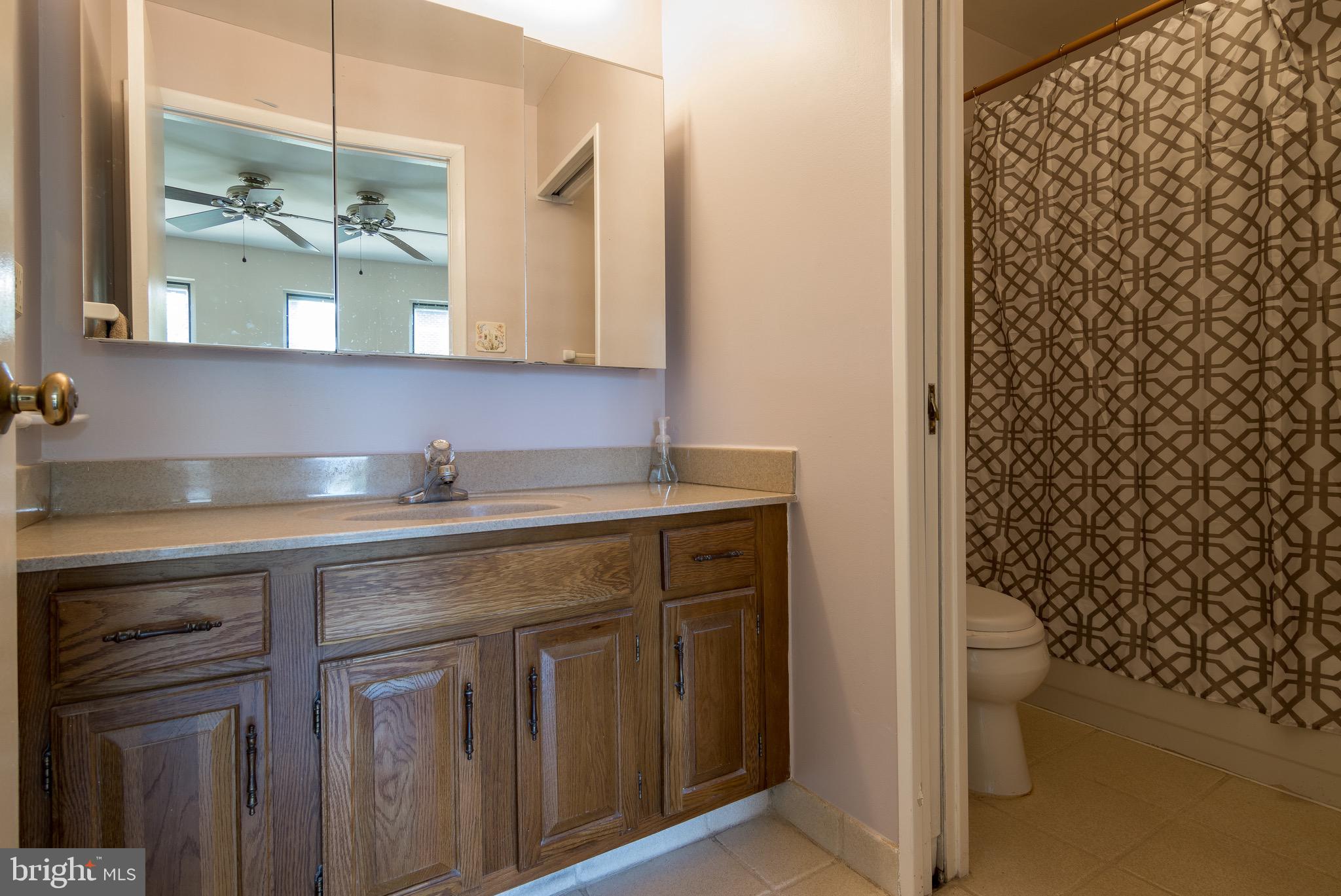 627 South Hanover Street Baltimore, MD 21230 - Photo 22 of 41 a bathroom with a granite countertop sink a toilet and a shower