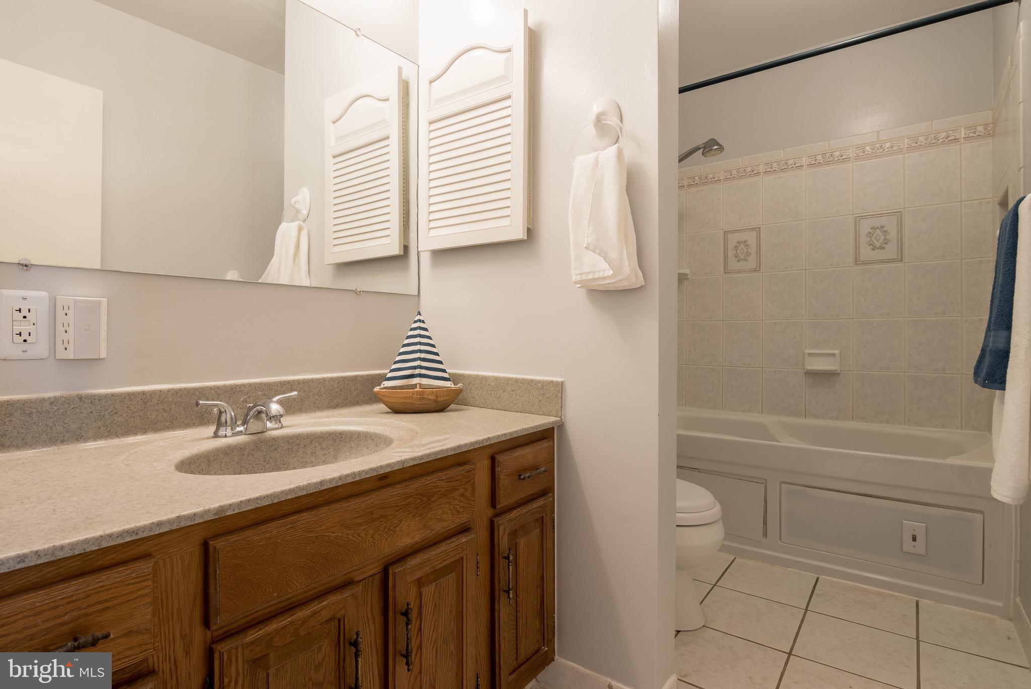 627 South Hanover Street Baltimore, MD 21230 - Photo 25 of 41 a bathroom with a granite countertop sink toilet and shower