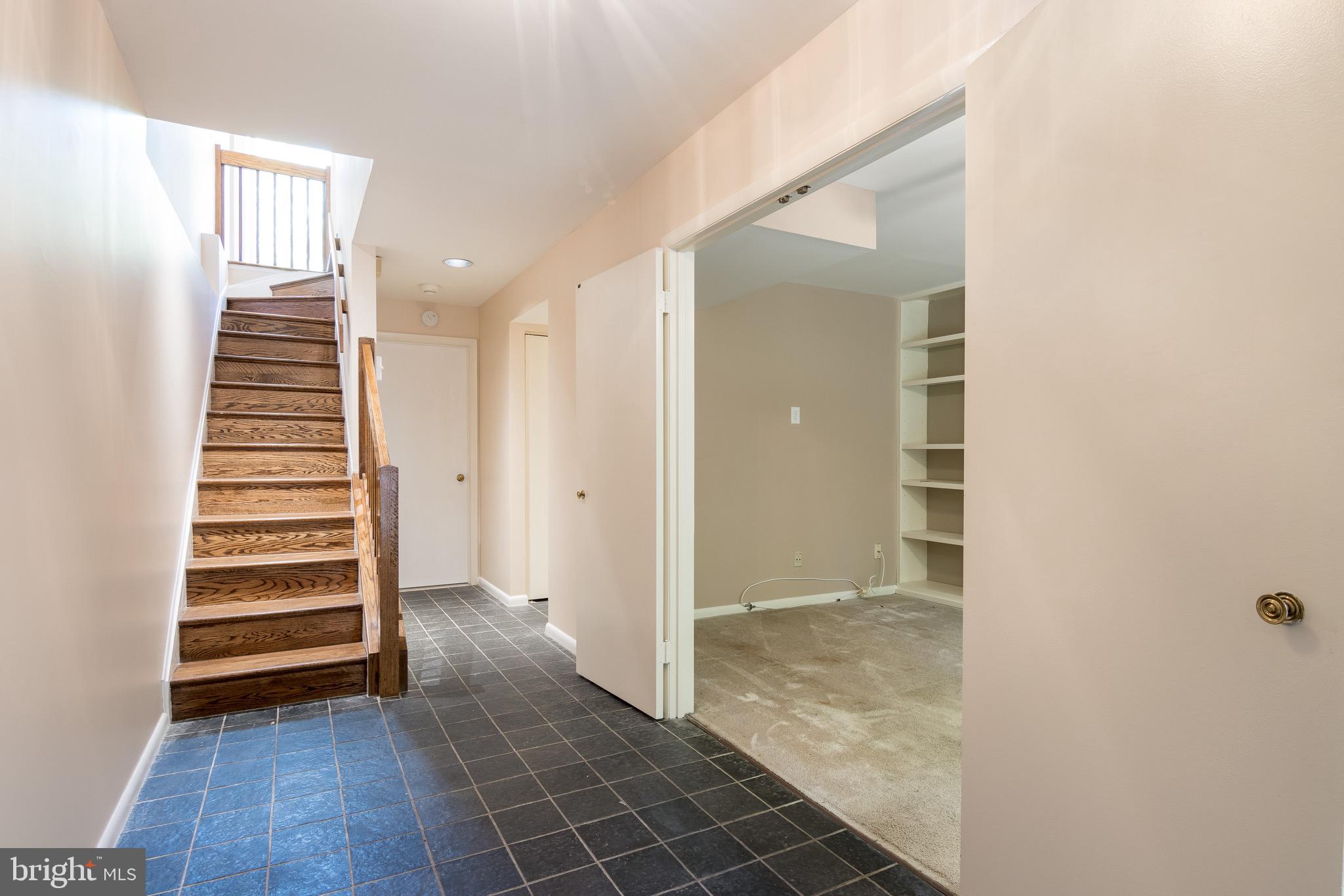 627 South Hanover Street Baltimore, MD 21230 - Photo 4 of 41 a view of a hallway with stairs and a window