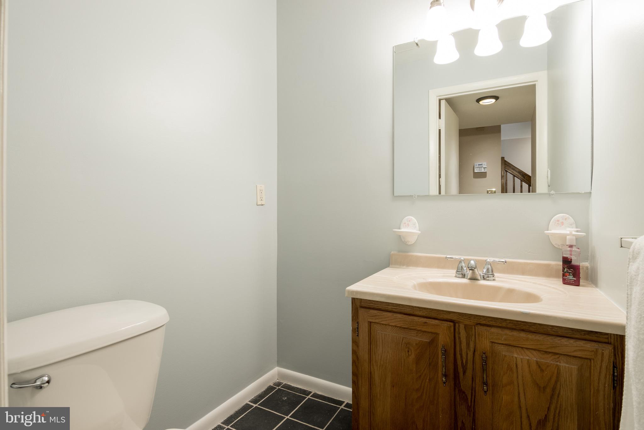 627 South Hanover Street Baltimore, MD 21230 - Photo 6 of 41 a bathroom with a sink a toilet and mirror