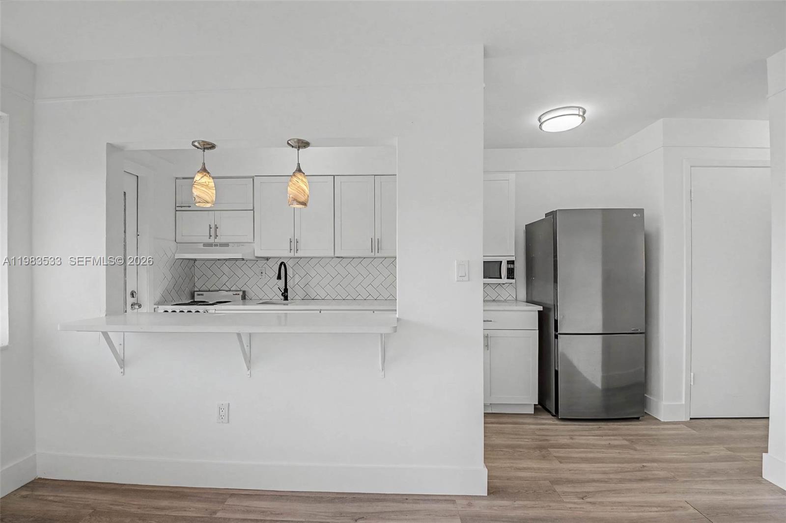 60 Northwest 79th Street, Unit 10 Miami, FL 33150 - Photo 3 of 18 a kitchen with stainless steel appliances granite countertop a refrigerator and a sink