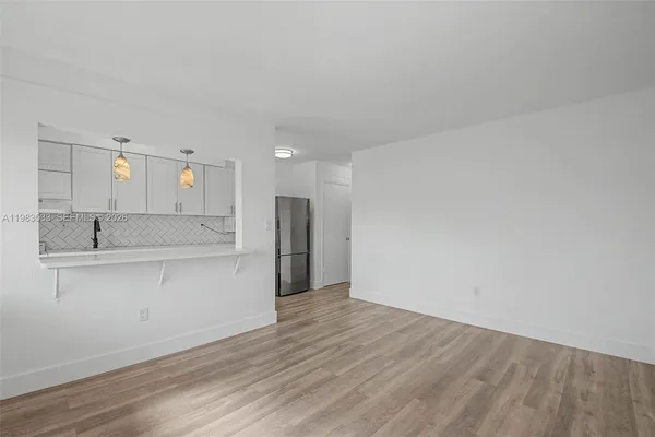 a view of a kitchen with wooden floor