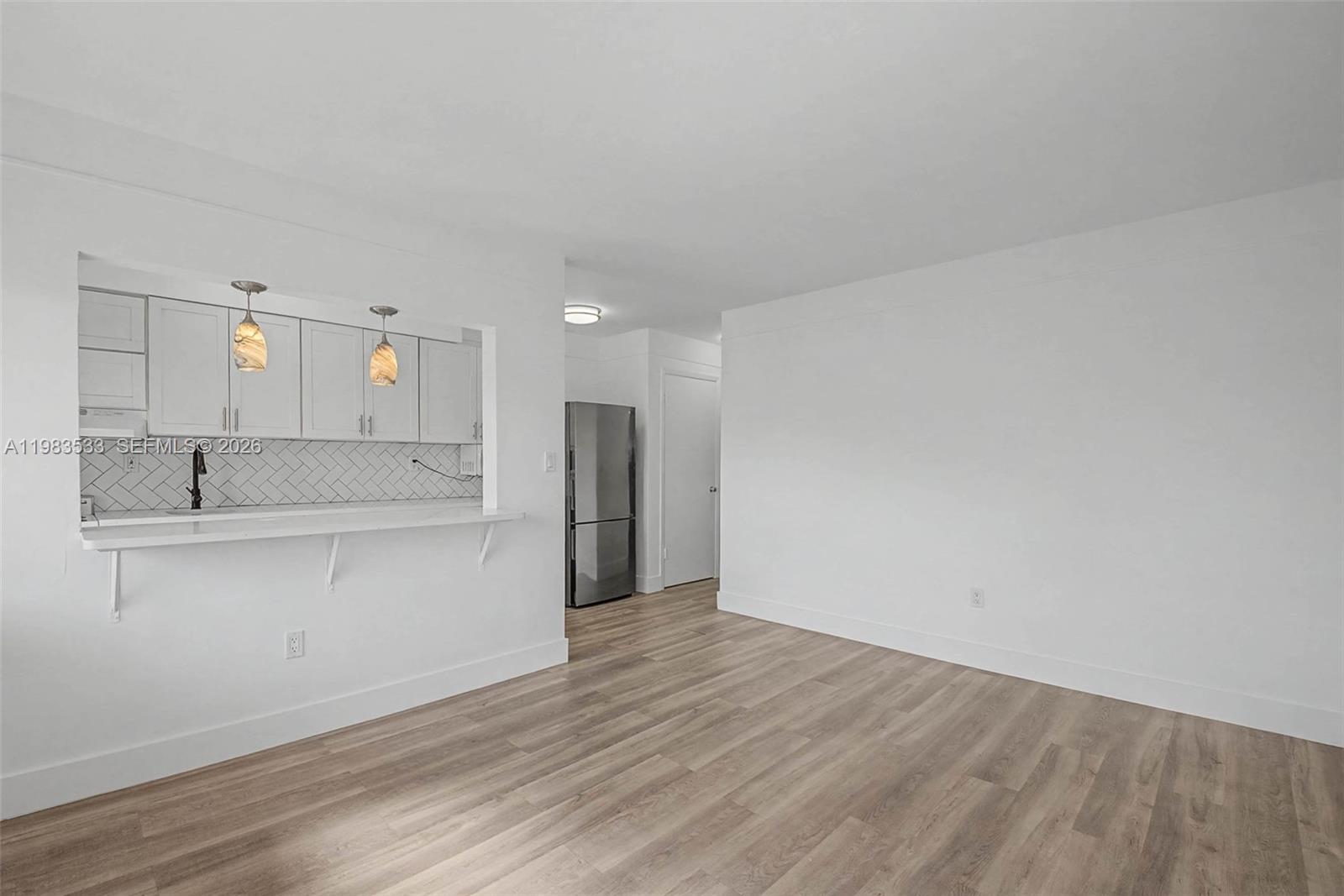 60 Northwest 79th Street, Unit 10 Miami, FL 33150 - Photo 5 of 18 a view of a kitchen with wooden floor