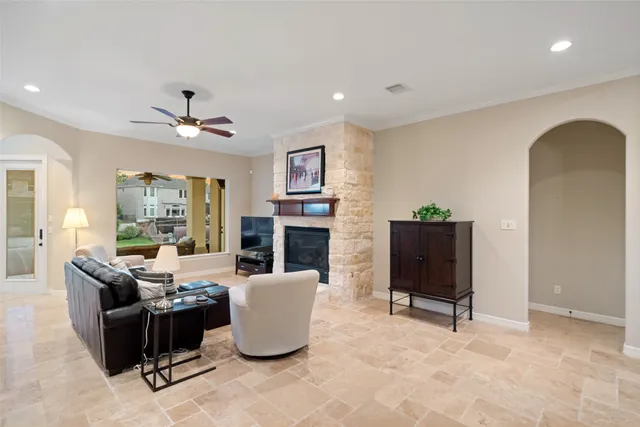 a dining room with furniture large windows and a chandelier