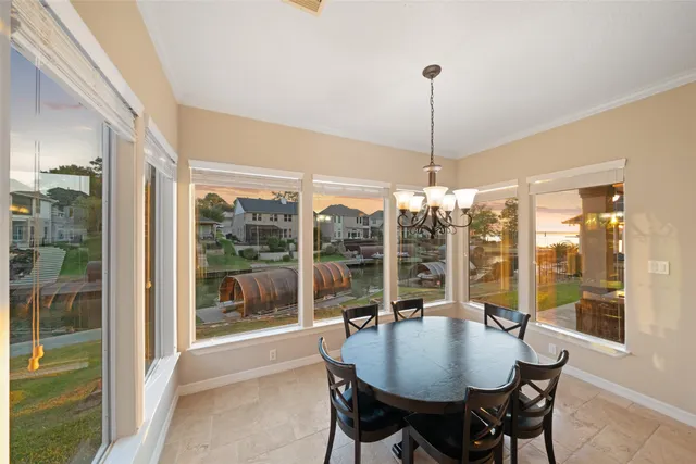 a dining room filled chandelier and wooden floor