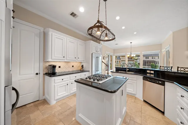 a open kitchen with stainless steel appliances granite countertop a sink stove and refrigerator