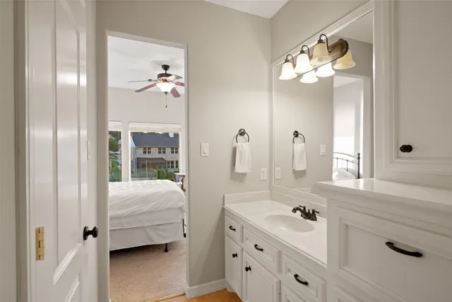 a bathroom with a granite countertop sink a toilet and shower