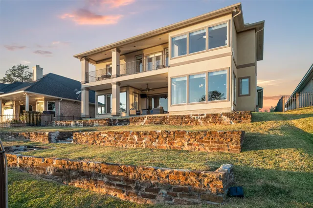 an aerial view of ocean and residential houses with outdoor space