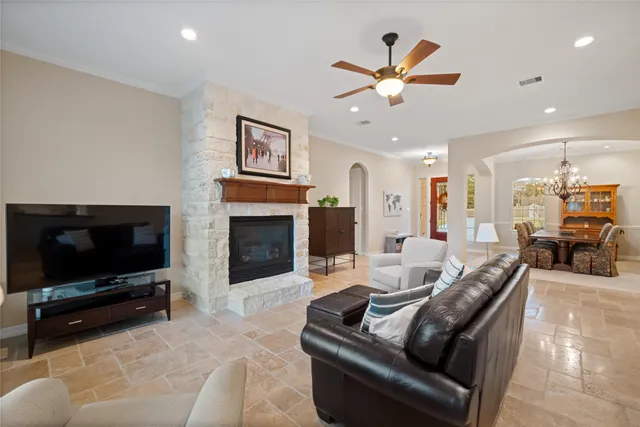 a living room with furniture a flat screen tv and a fireplace