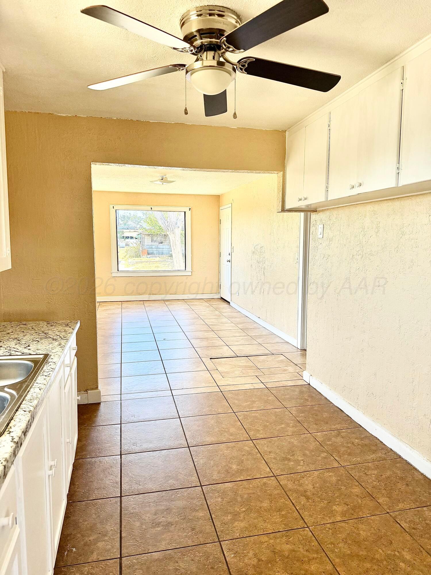 310 Coble Street Borger, TX 79007 - Photo 2 of 7 a view of a kitchen with a stove and a window