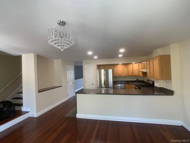a large white kitchen with a large window