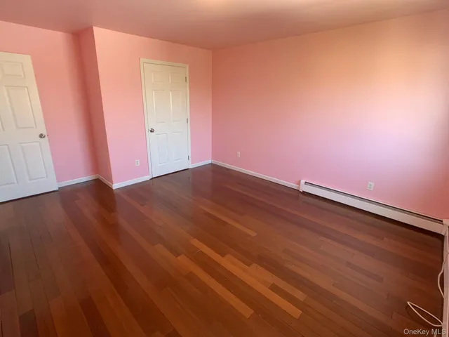 an empty room with wooden floor