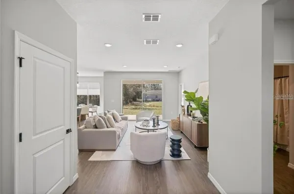 a living room with furniture and a potted plant