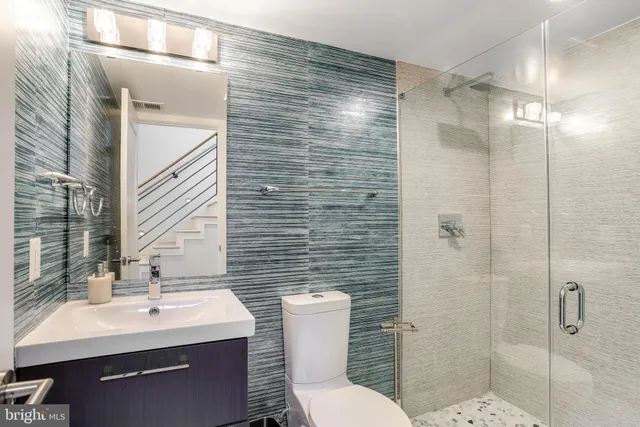 a bathroom with a sink toilet and shower