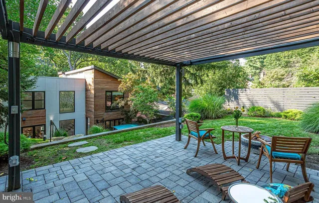a patio with glass table and chairs