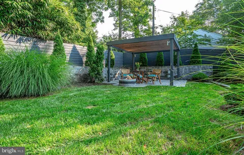 a view of a house with backyard sitting area and garden