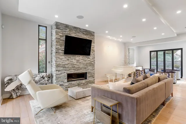a living room with furniture a fireplace and a flat screen tv
