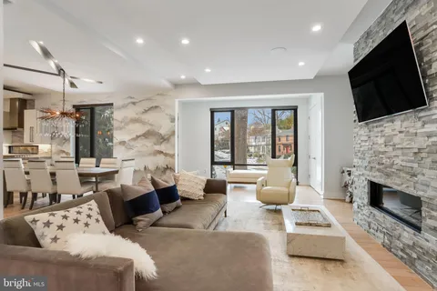 a living room with fireplace furniture and a flat screen tv