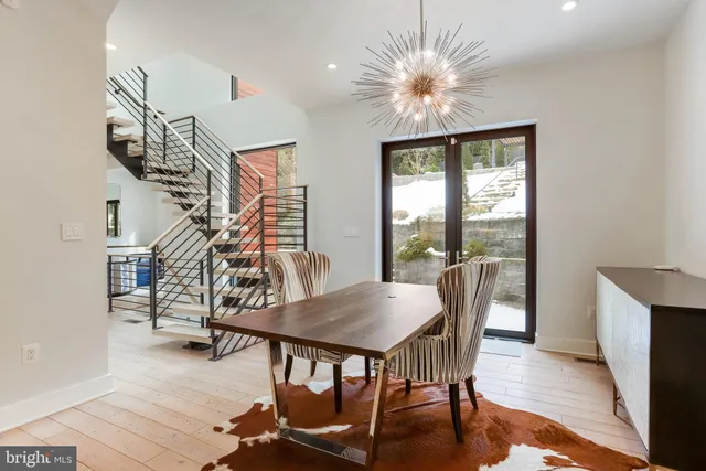 a dining room with furniture entryway and wooden floor