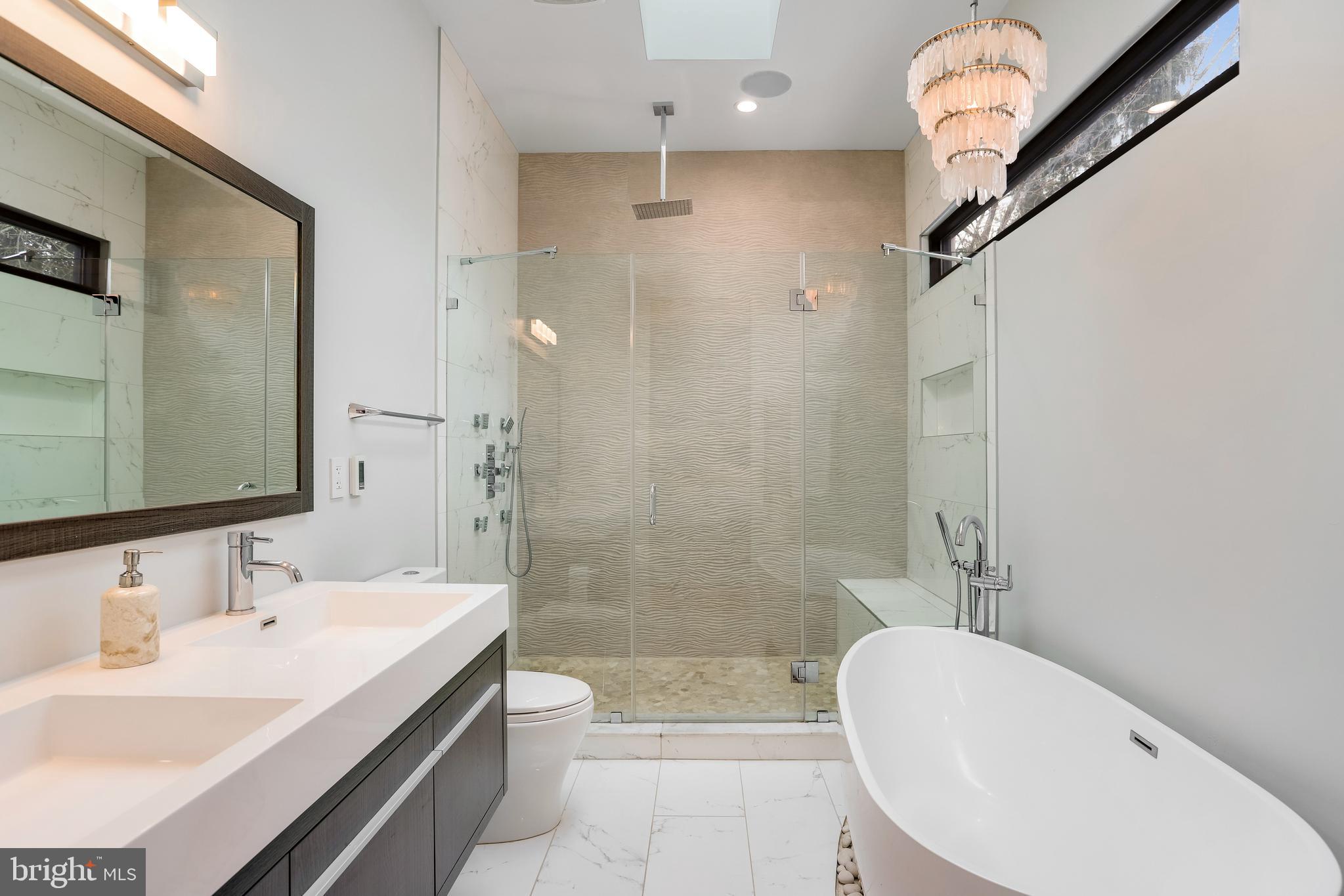 2927 Arizona Avenue Northwest Washington, DC 20016 - Photo 9 of 18 a bathroom with a sink a toilet a mirror and shower