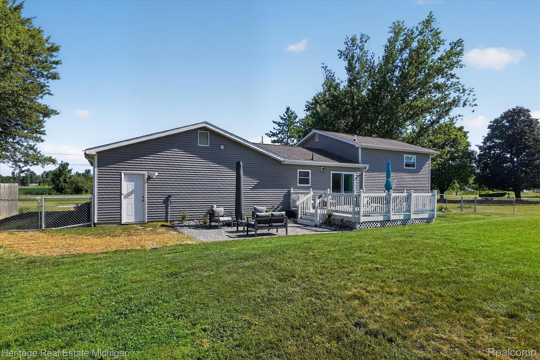 7225 Baldwin Road Swartz Creek, MI 48473 - Photo 35 of 44 Expansive green lawn bordering a chain-link fence