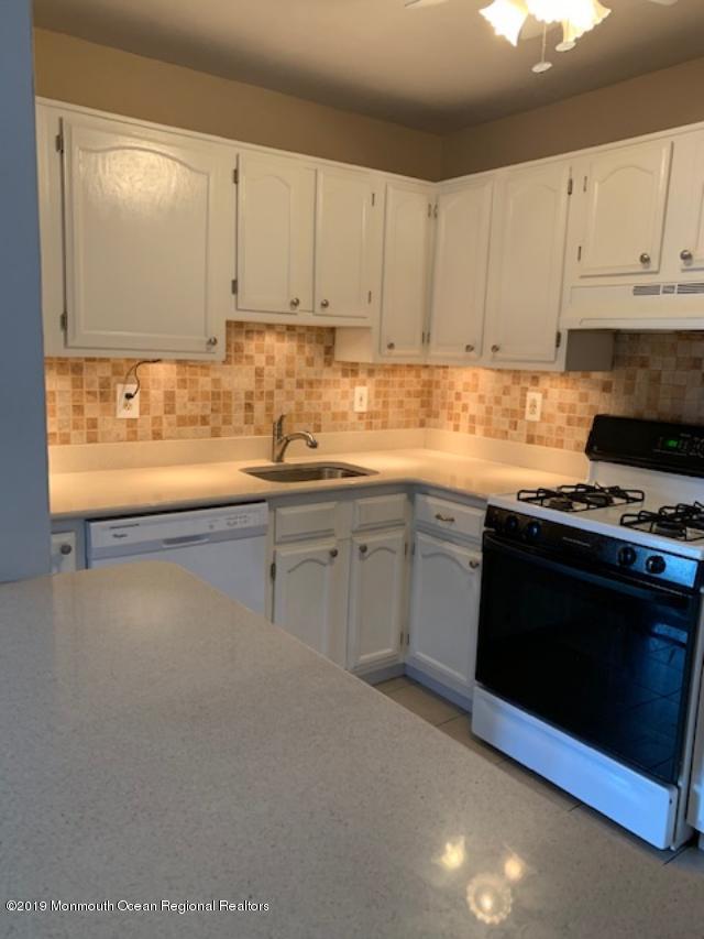 462 Magnolia Court Howell, NJ 07731 - Photo 1 of 2 a kitchen with granite countertop white cabinets and white appliances
