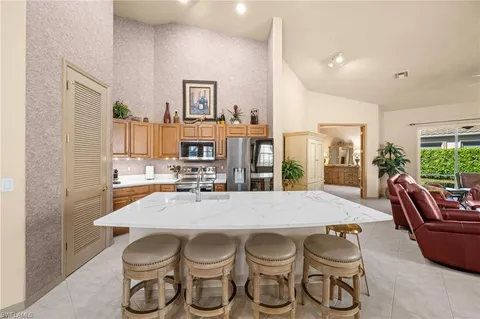 a large kitchen with a table and chairs