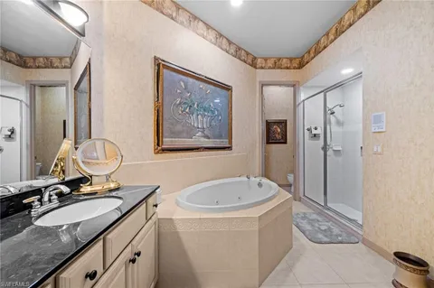 a bathroom with a sink vanity mirror and toilet