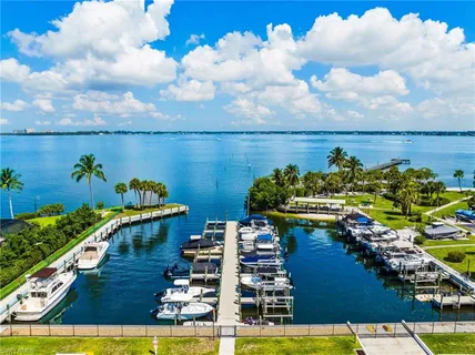 a view of a ocean with boats and palm trees