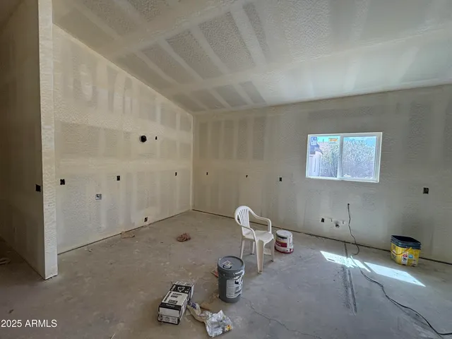 an empty room with windows and view of an empty room