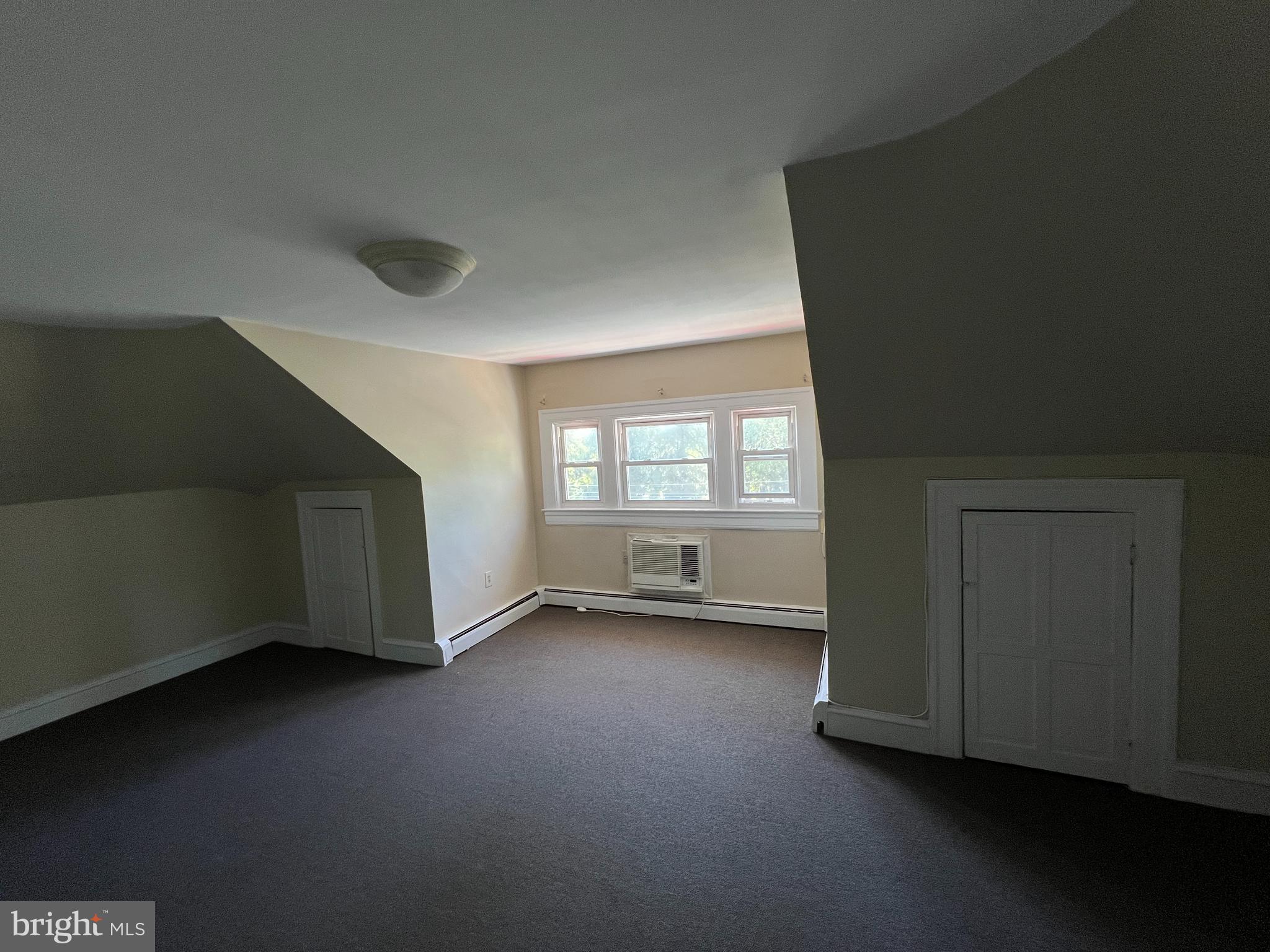 1050 Stuyvesant Avenue Trenton, NJ 08618 - Photo 5 of 11 an empty room with wooden floor and windows