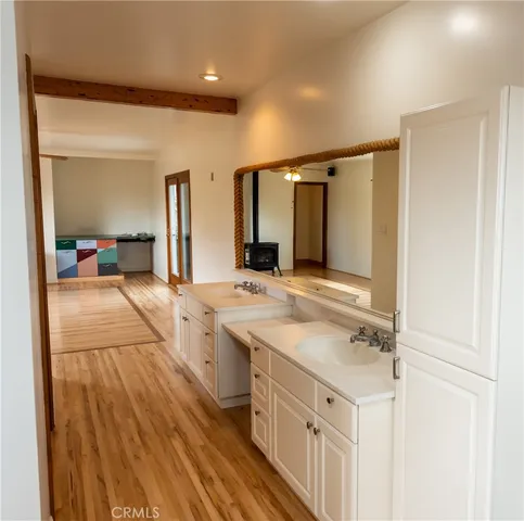 a spacious bathroom with a double vanity sink and mirror