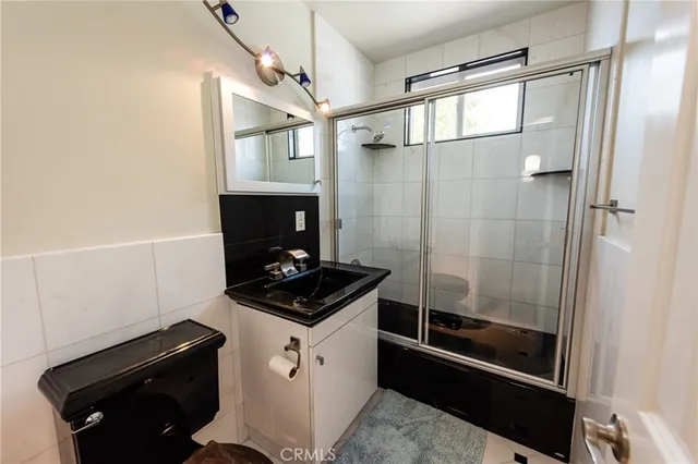 a bathroom with a shower and a sink