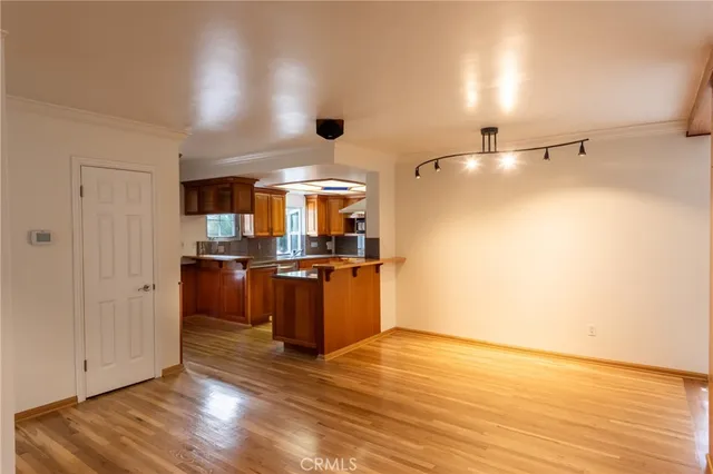 a view of a kitchen with wooden floor
