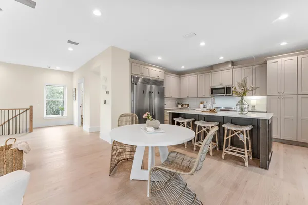 a kitchen with kitchen island white cabinets and white appliances