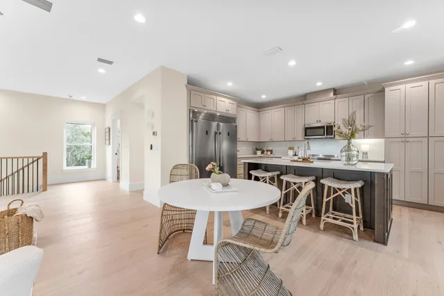 a kitchen with kitchen island white cabinets and white appliances