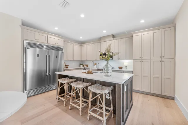 a living room with furniture and kitchen view