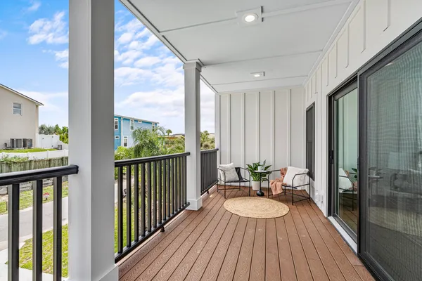 a view of balcony with wooden floor