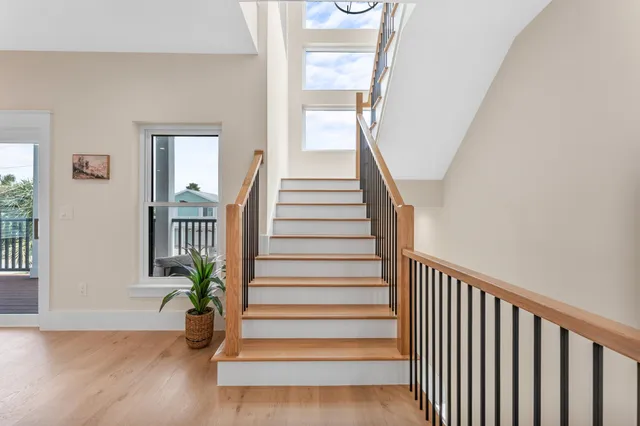 a view of staircase with railing and white walls