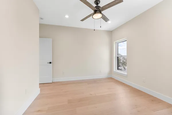 a bathroom with a granite countertop sink a toilet and a mirror