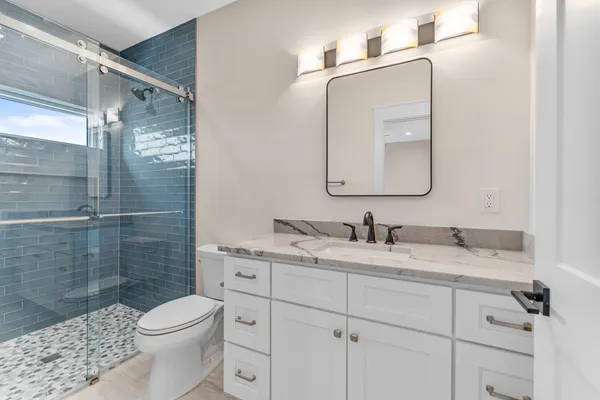a bathroom with a double vanity sink and a mirror