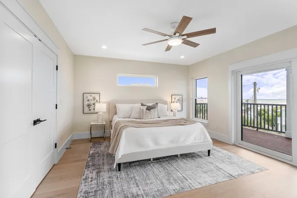 a spacious bedroom with a bed and a chandelier