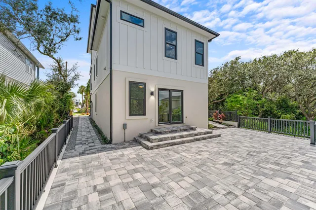 an aerial view of a house with a garden and lake view