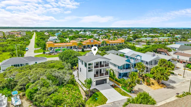 an aerial view of residential building with outdoor space and ocean view