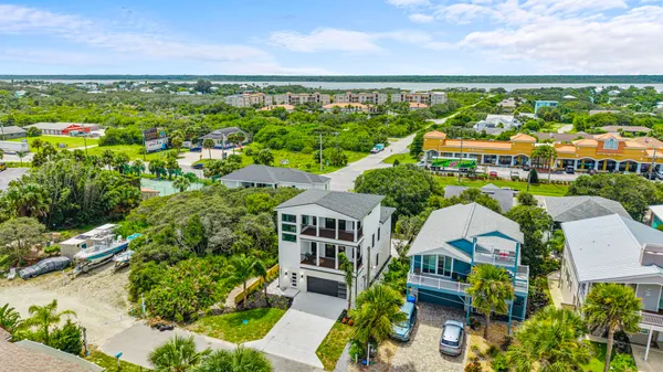 an aerial view of residential building with outdoor space and ocean view