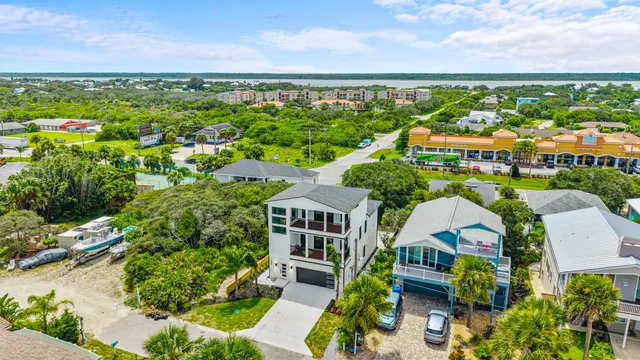 an aerial view of residential building with outdoor space and ocean view