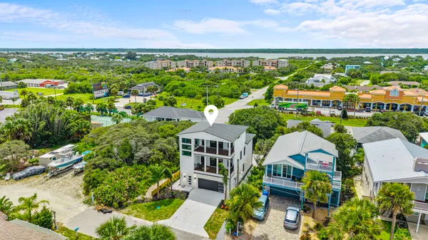 an aerial view of residential building with outdoor space and ocean view