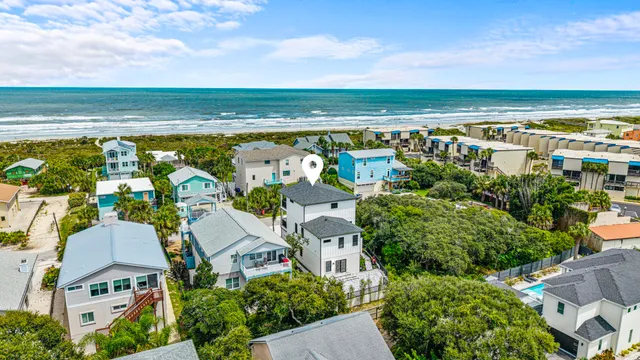 an aerial view of a residential apartment building with a yard and large tree