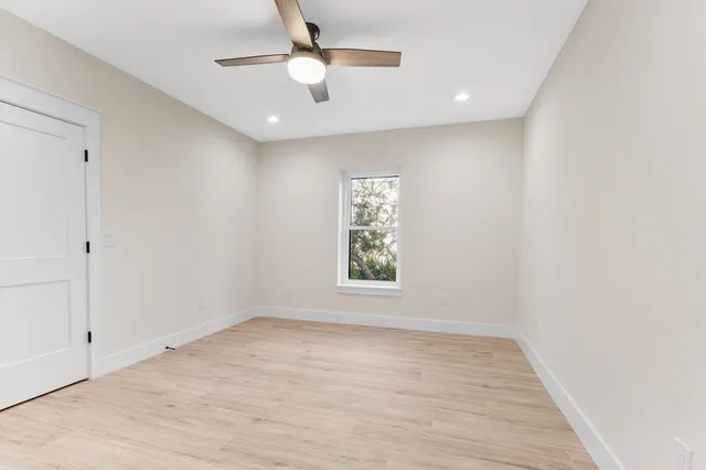 wooden floor in an empty room with a window