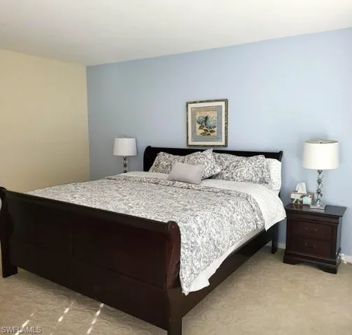 a bedroom with a bed window and dresser